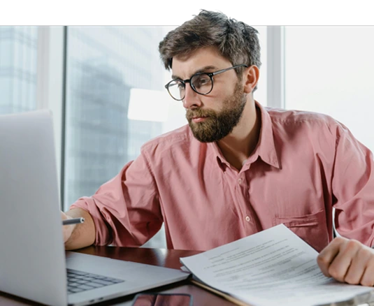 Worker reviewing work on a laptop